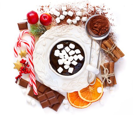 simsearch:400-08338397,k - Cup of creamy hot chocolate with marshmallows surrounded food ingredients and some christmas decoration on white background with place for text. Photographie de stock - Aubaine LD & Abonnement, Code: 400-08401165