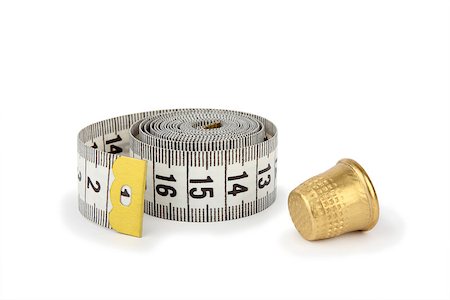 simsearch:400-06472161,k - Gray measuring tape and thimble, isolated on white background Stock Photo - Budget Royalty-Free & Subscription, Code: 400-08401211