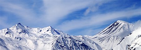 simsearch:400-08671175,k - Panoramic view on winter snowy mountains in windy day. Caucasus Mountains, Georgia. Ski resort Gudauri. Stock Photo - Budget Royalty-Free & Subscription, Code: 400-08401541