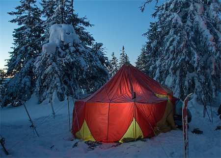 Overnight stop ( bivouac) in winter extreme travel. This is a ski travel. Big bright tourist tent against winter forest background. Fotografie stock - Microstock e Abbonamento, Codice: 400-08401998