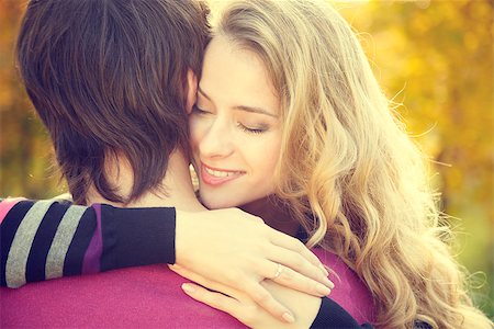 simsearch:400-04702706,k - Young Happy Woman Embracing Her Boyfriend on Autumn Background. Dating and Relationship Concept. Toned Photo. Stockbilder - Microstock & Abonnement, Bildnummer: 400-08402234