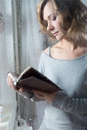 Portrait of Young woman reading throw the rain drops Stock Photo - Budget Royalty-Free & Subscription, Code: 400-08402351
