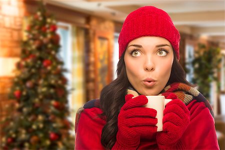 person in gloves holding cup of hot cocoa - Warm Mixed Race Woman Wearing Winter Hat and Gloves In Christmas Setting. Stock Photo - Budget Royalty-Free & Subscription, Code: 400-08402502
