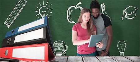 simsearch:400-07683612,k - Creative team looking at digital tablet against green chalkboard Stock Photo - Budget Royalty-Free & Subscription, Code: 400-08414189