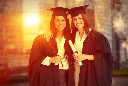 Two women embracing each other after they graduated from university against grey school building Stock Photo - Budget Royalty-Free & Subscription, Code: 400-08414325