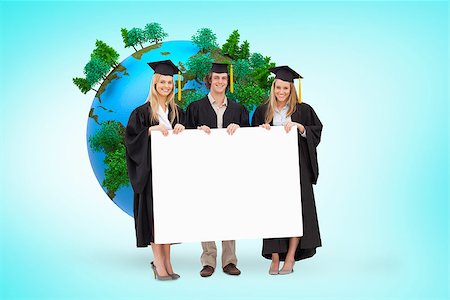 Three students in graduate robe holding a blank sign against blue vignette background Stock Photo - Budget Royalty-Free & Subscription, Code: 400-08414401