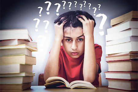 Tensed boy sitting with stack of books against grey vignette Stock Photo - Budget Royalty-Free & Subscription, Code: 400-08414425