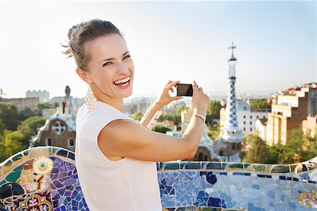 simsearch:400-08415527,k - Refreshing promenade in unique Park Guell style in Barcelona, Spain. Happy young woman tourist taking photo with digital photo camera while standing in Park Guell, Barcelona, Spain Stock Photo - Budget Royalty-Free & Subscription, Code: 400-08415536