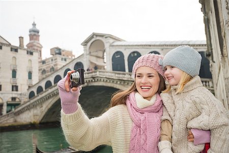 Modern family taking a winter break to enjoy inspirational adventure in Venice, Italy. Mother and daughter taking photos while standing in front of Ponte di Rialto Stock Photo - Budget Royalty-Free & Subscription, Code: 400-08415554