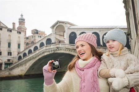 simsearch:400-08134687,k - Modern family taking a winter break to enjoy inspirational adventure in Venice, Italy. Happy mother and daughter taking photos while standing in front of Rialto Bridge Stock Photo - Budget Royalty-Free & Subscription, Code: 400-08415555