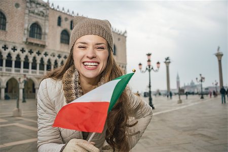 simsearch:400-08344334,k - Delightful Venice, Italy can help make the most of your next winter getaway. Portrait of happy young woman tourist with Italian flag standing on St. Mark's Square near Dogi Palace Stock Photo - Budget Royalty-Free & Subscription, Code: 400-08415687