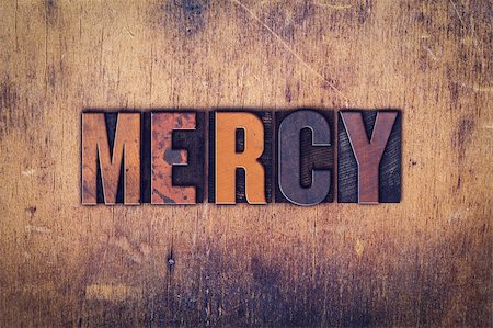 The word "Mercy" written in dirty vintage letterpress type on a aged wooden background. Photographie de stock - Aubaine LD & Abonnement, Code: 400-08410164