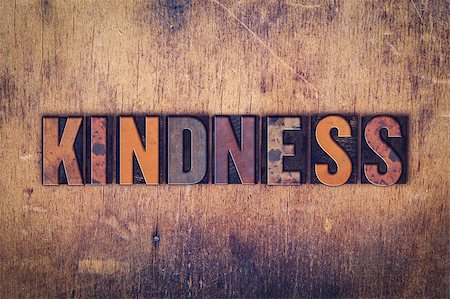 The word "Kindness" written in dirty vintage letterpress type on a aged wooden background. Stockbilder - Microstock & Abonnement, Bildnummer: 400-08411129