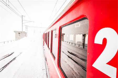 simsearch:400-07680071,k - A red train in the middle of a desert of snow Photographie de stock - Aubaine LD & Abonnement, Code: 400-08411758