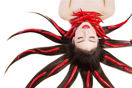 simsearch:400-07899696,k - Closeup portrait of beautiful young woman lying with red chilli peppers in hair. Isolated on white background. Photographie de stock - Aubaine LD & Abonnement, Code: 400-08426768