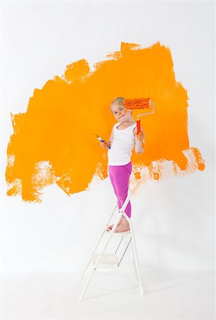 Little girl painting white wall with orange color Stock Photo - Budget Royalty-Free & Subscription, Code: 400-08426760