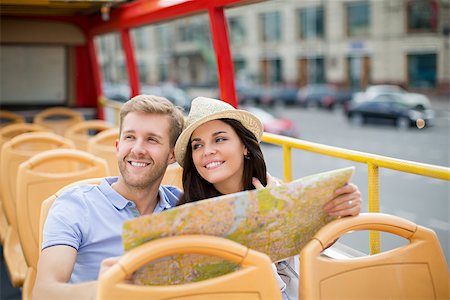Smiling couple with a map of the tour bus Stock Photo - Budget Royalty-Free & Subscription, Code: 400-08426793