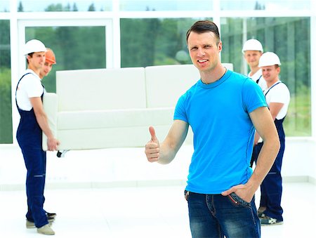 happy male movers in uniform carrying white sofa Stock Photo - Budget Royalty-Free & Subscription, Code: 400-08427398