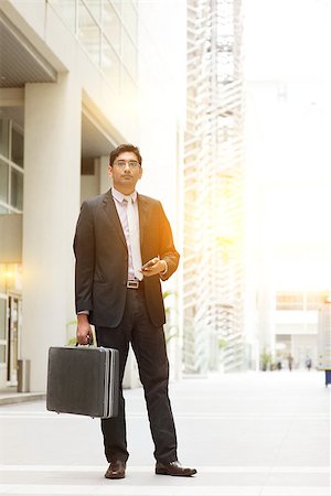 Portrait of fullbody Asian Indian business man standing outside modern office building block, beautiful golden sunlight at background. Stock Photo - Budget Royalty-Free & Subscription, Code: 400-08427555