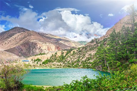 Beautiful lake in mountains against blue sky with white clouds in Annapurna area Stock Photo - Budget Royalty-Free & Subscription, Code: 400-08427881