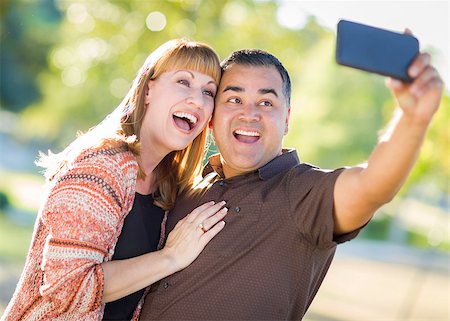 feverpitched (artist) - Attractive Mixed Race Couple Taking Self Portraits in the Park. Foto de stock - Royalty-Free Super Valor e Assinatura, Número: 400-08428010