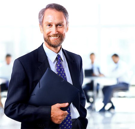 simsearch:400-08159452,k - adult man smiling looking at the camera with a folder in his hands Stock Photo - Budget Royalty-Free & Subscription, Code: 400-08428528