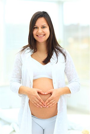 simsearch:400-08529613,k - woman holds her baby bump and looking up Stock Photo - Budget Royalty-Free & Subscription, Code: 400-08428790