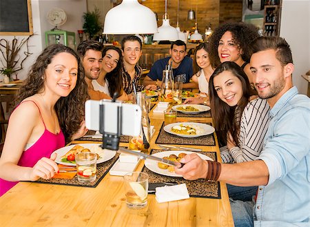 selfie stick - Multi-Ethnic group of happy friends lunching and making a selfie Stock Photo - Budget Royalty-Free & Subscription, Code: 400-08428853