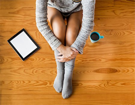 socks and floor and leg - Woman sitting on the floor drinking a coffee Stock Photo - Budget Royalty-Free & Subscription, Code: 400-08428869