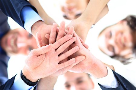 business people group joining hands and representing concept of friendship and teamwork, low angle view Stock Photo - Budget Royalty-Free & Subscription, Code: 400-08429156
