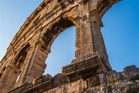 round amphitheatre - Architecture Details of the Roman Amphitheater Arena in Sunny Summer Evening with Clear Blue Sky as Background. Famous Travel Destination in Pula, Croatia. Stock Photo - Budget Royalty-Free & Subscription, Code: 400-08430103