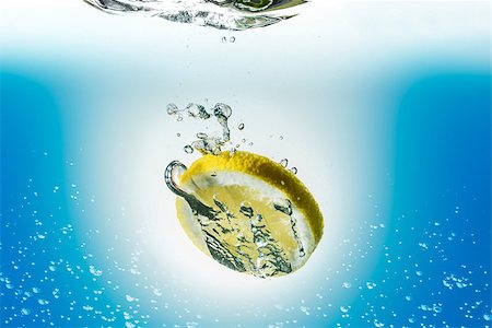 Image of a lemon slice falling in water Stock Photo - Budget Royalty-Free & Subscription, Code: 400-08430254