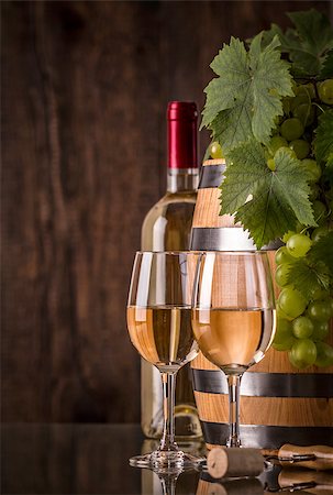 simsearch:400-08110621,k - Glasses of wine with bottle barrel grapes and dark background Stock Photo - Budget Royalty-Free & Subscription, Code: 400-08430383