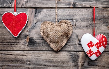 simsearch:400-08034173,k - Love concept. Hearts hanging on a string, shot on wooden background Stockbilder - Microstock & Abonnement, Bildnummer: 400-08431053