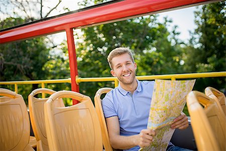 Young man with a map in the tour bus Stock Photo - Budget Royalty-Free & Subscription, Code: 400-08431105