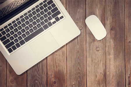 Top view working desk with laptop computer. Wooden table background with copy space in vintage toned. Stock Photo - Budget Royalty-Free & Subscription, Code: 400-08431173