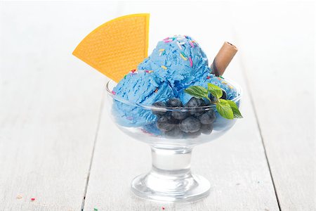 simsearch:400-08225242,k - Blue ice cream in cup with blueberry fruits and waffle on white rustic wooden background. Stockbilder - Microstock & Abonnement, Bildnummer: 400-08431196