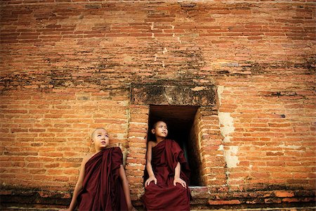Young Buddhist novice monks at outside monastery, pagan, Myanmar. Stock Photo - Budget Royalty-Free & Subscription, Code: 400-08431211