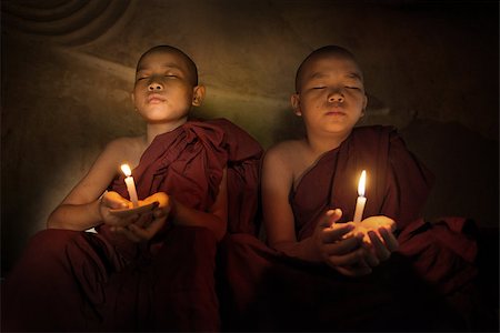 Little monks praying with candlelight Stock Photo - Budget Royalty-Free & Subscription, Code: 400-08431212