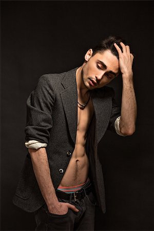 smart models male - Studio shot of young male in jeans and jacket wearing on shirtless body isolated over black background. Stock Photo - Budget Royalty-Free & Subscription, Code: 400-08431390