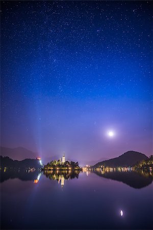 Illuminated Catholic Church on a Little Island and Bled Castle on Bled Lake in Slovenia at Night Reflected on Water Surface Stock Photo - Budget Royalty-Free & Subscription, Code: 400-08431514