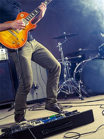 playing guitar and drums - Photo of a guitar player playing on stage. Stock Photo - Budget Royalty-Free & Subscription, Code: 400-08431804