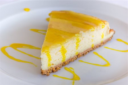 simsearch:400-06643502,k - Lemon cheese cake with sauce served on a white plate Photographie de stock - Aubaine LD & Abonnement, Code: 400-08431856
