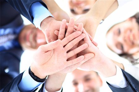 Small group of business people joining hands, low angle view. Stock Photo - Budget Royalty-Free & Subscription, Code: 400-08432290