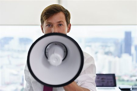 simsearch:6109-06195330,k - Young executive office worker holding megaphone and speaking at camera with confidence. Copy space Photographie de stock - Aubaine LD & Abonnement, Code: 400-08433254