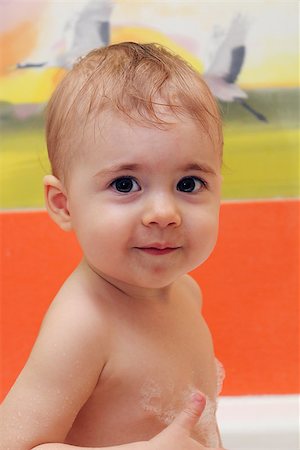small child the age of one year plays in the bathroom. Stock Photo - Budget Royalty-Free & Subscription, Code: 400-08433284