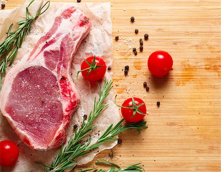 simsearch:400-07713408,k - Pieces of crude meat with rosemary and tomatoes. Stock Photo - Budget Royalty-Free & Subscription, Code: 400-08433322