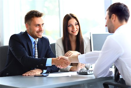 Business people shaking hands, finishing up a meeting Stock Photo - Budget Royalty-Free & Subscription, Code: 400-08494361