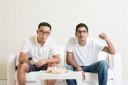 Men sitting on couch watching football match on television, Asian people friendship at home. Stock Photo - Budget Royalty-Free & Subscription, Code: 400-08494559
