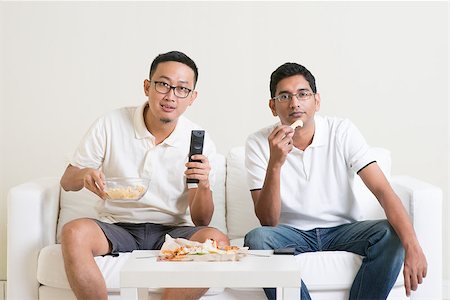 Group of friends sitting on sofa watching football match on television together at home. Stock Photo - Budget Royalty-Free & Subscription, Code: 400-08494551